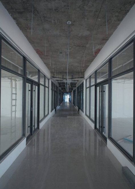 Block A corridor lined with glass-fronted units